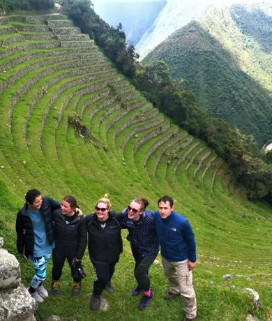Happy tourists gathered on the agricultural terraces of Wiñaywayna