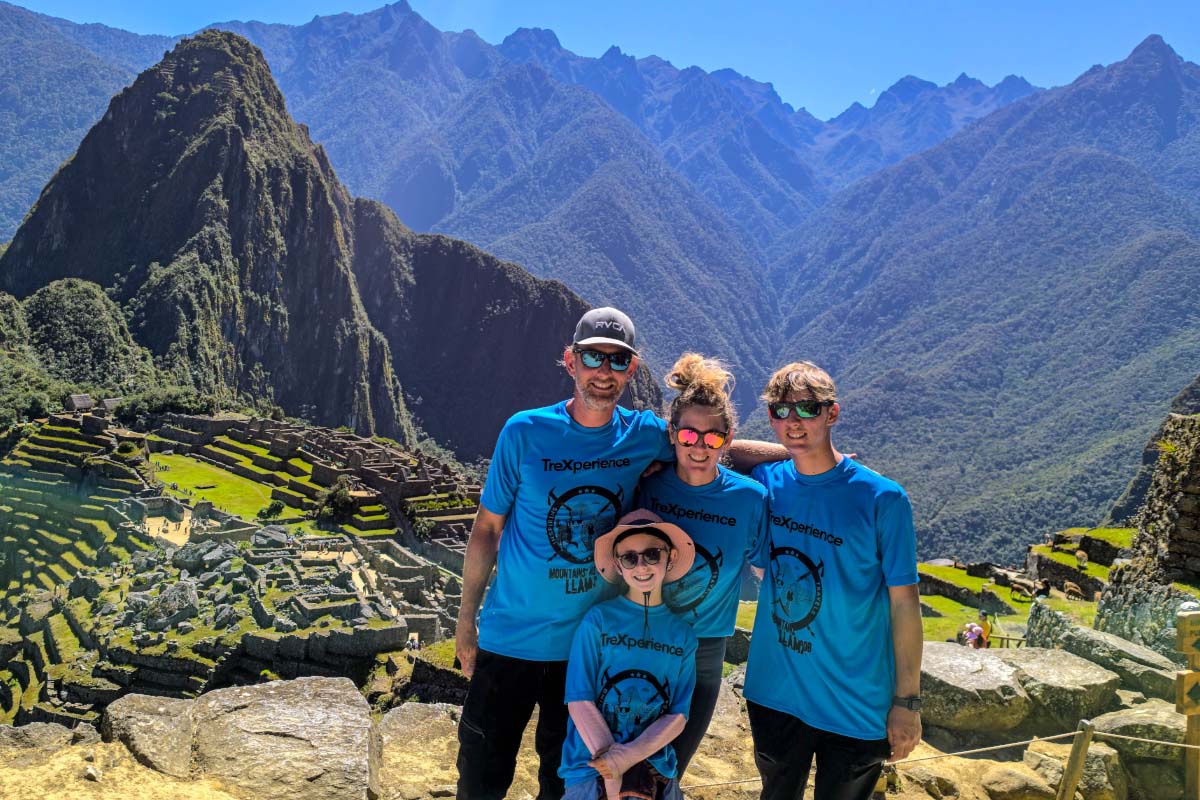 Family posing for a photo with Machu Picchu in the background | TreXperience Family posing for a photo with Machu Picchu in the background | TreXperience