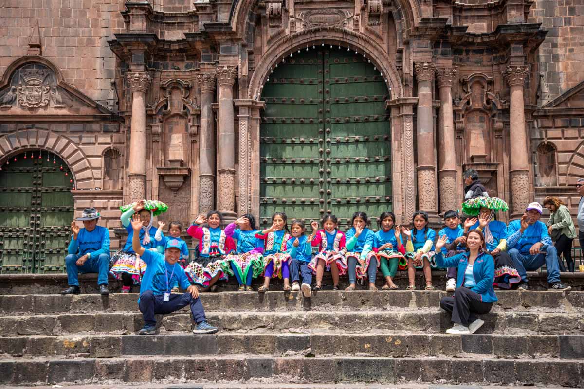 Patapallpa children in front of Cusco Cathedral taking a photo of themselves | TreXperience