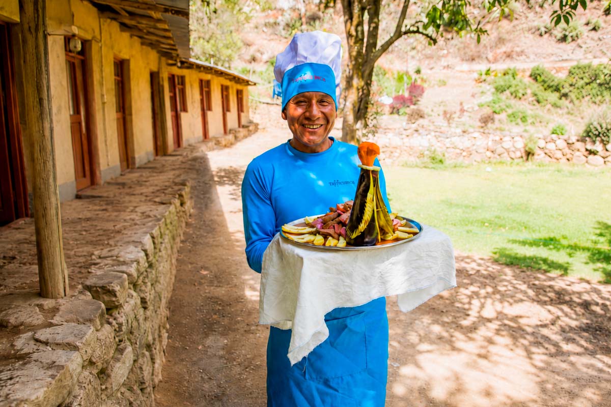 TreXperience chef in blue uniform holding a dish | TreXperience