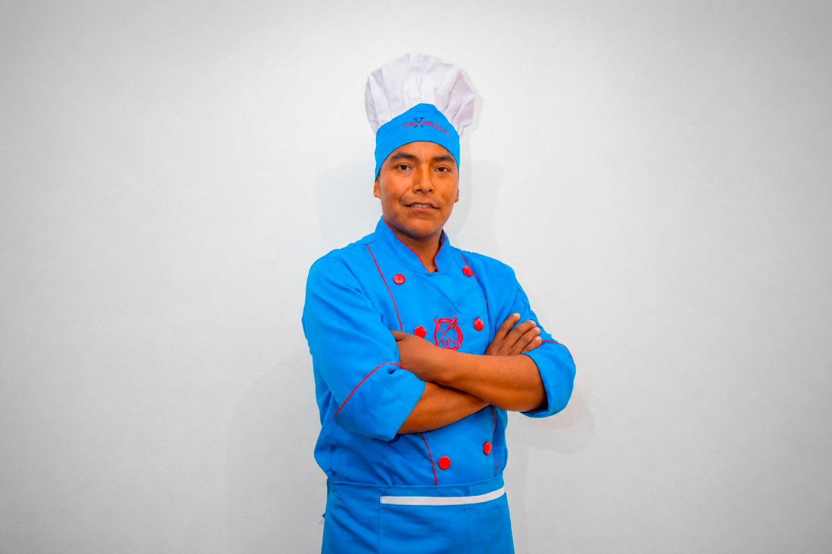 Cocinero especializado de TreXperience con uniforme azul y gorro | TreXperience