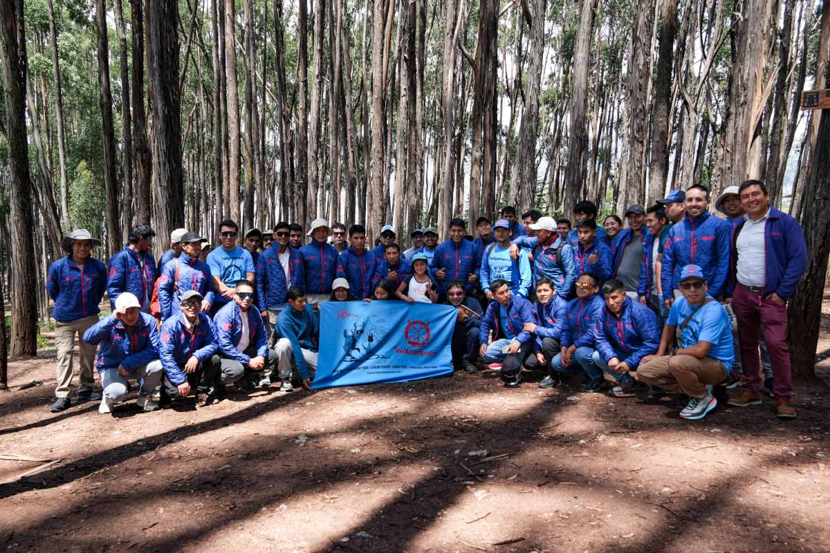 TreXperience tour guide staff with a banner in the Qenqo forest TreXperience tour guide staff with a banner in the Qenqo forest