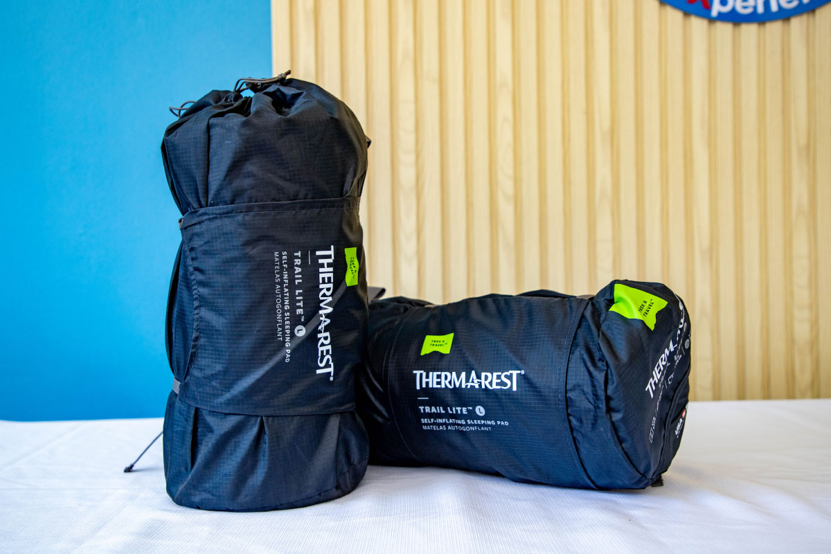 Black travel bags with green details Two black travel bags, one tall and one rectangular with green details, placed on a white surface | TreXperience