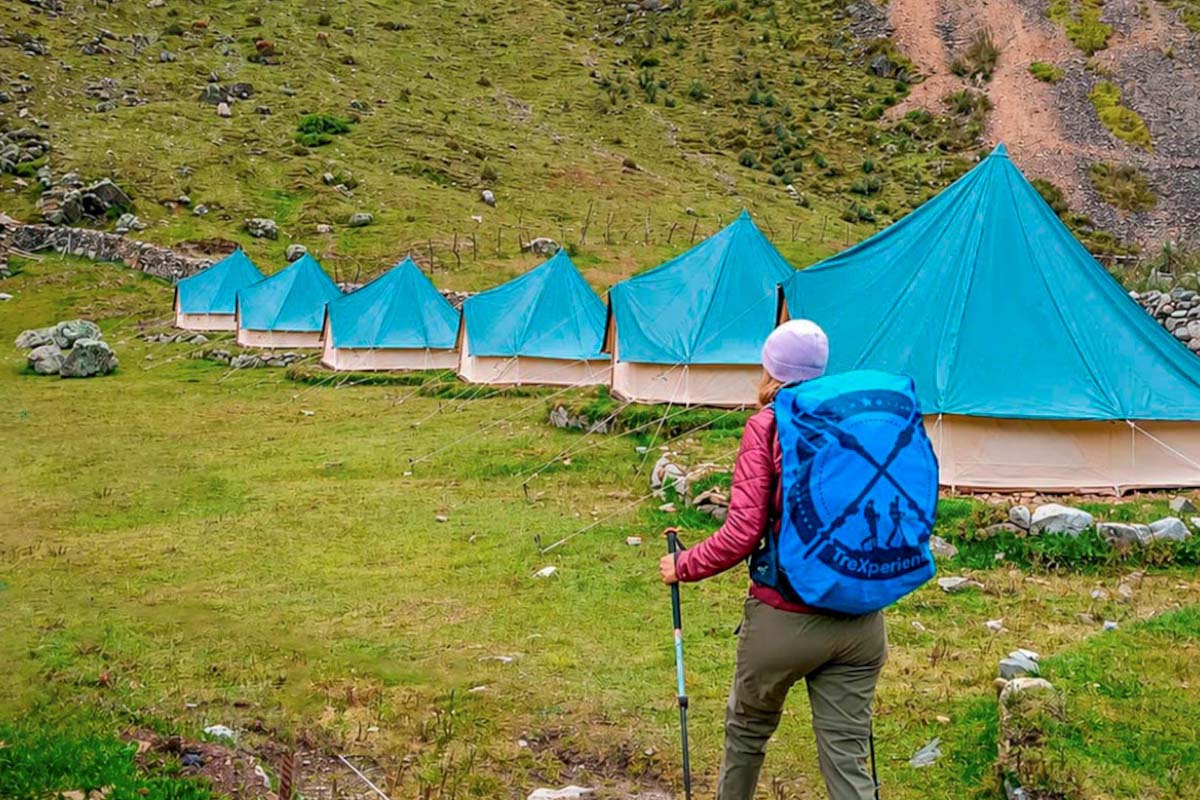 Hiker walking towards the Salkantay Glamp Camp Backpacker walking towards Salkantay Glamping shops | TreXperience