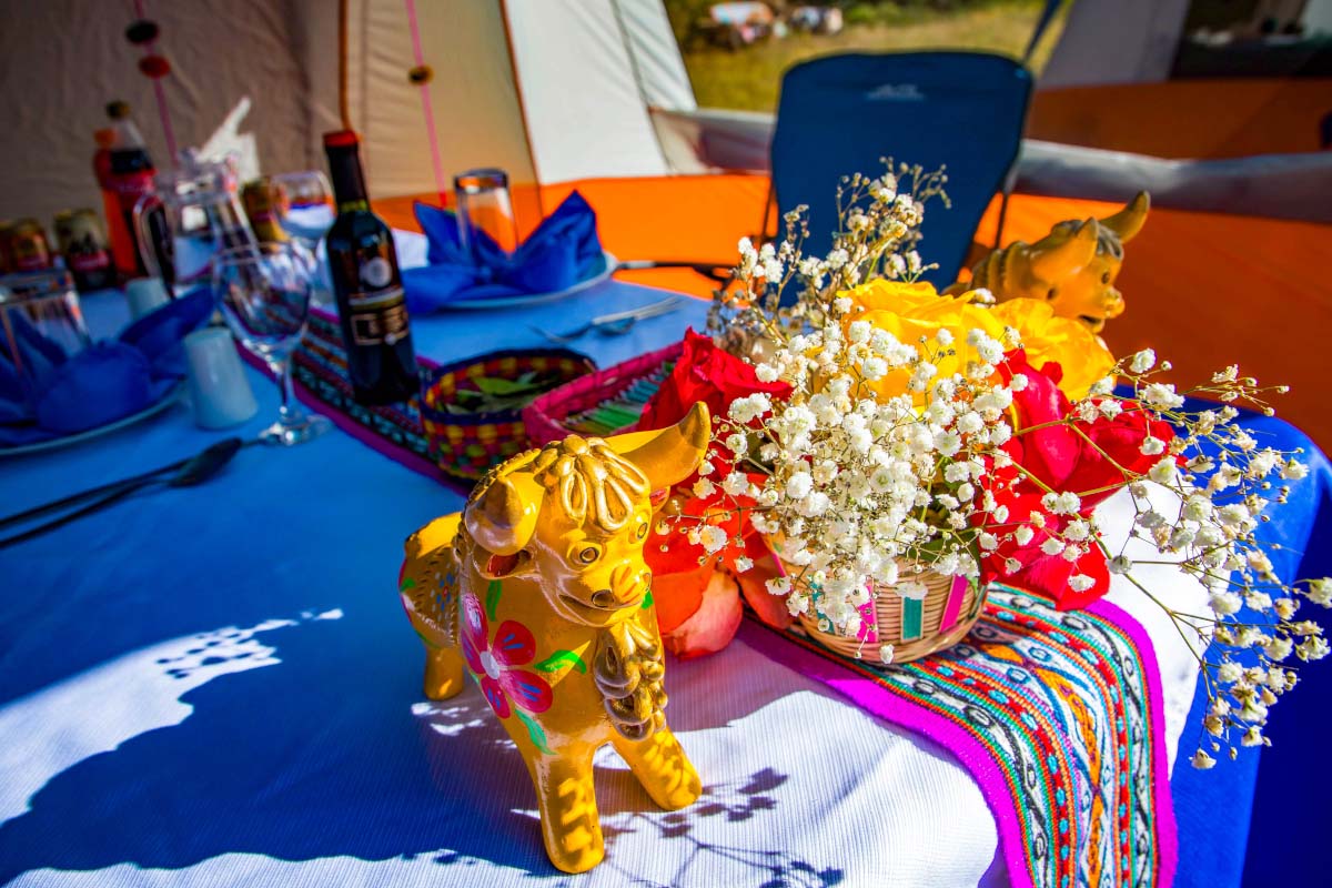 Decorative figures among Andean textiles Decorative animal figurines with colorful ornaments displayed on a table covered with Andean textiles | TreXperience