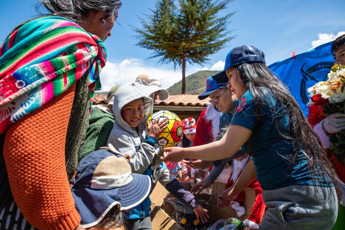 TreXperience staff distributing gifts to children