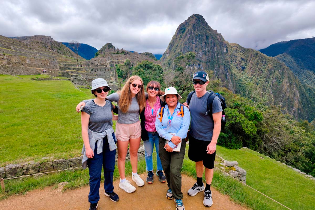Group of travelers with a female guide at Machu Picchu | TreXperience
