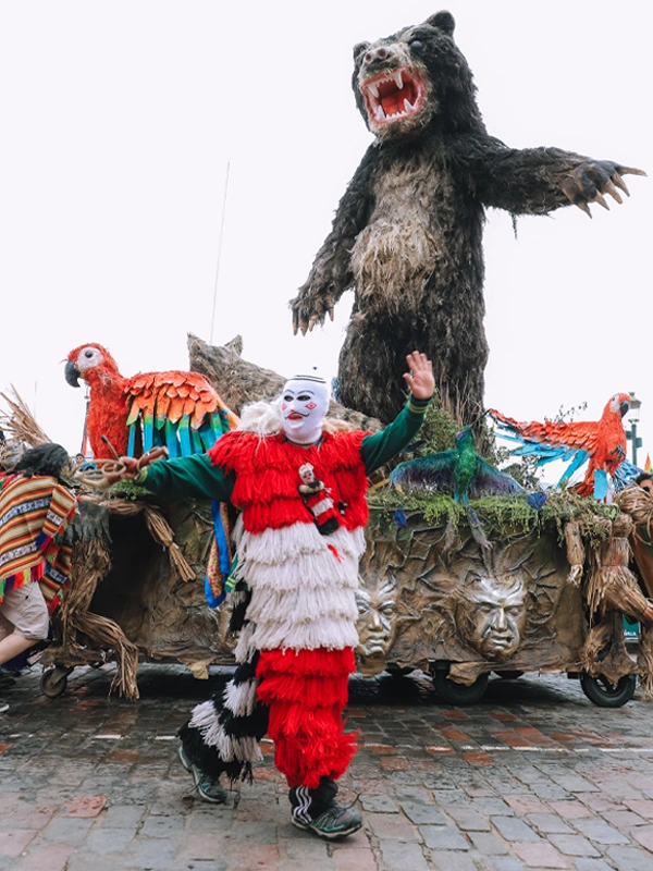 Allegorical float of the spectacled bear alongside its human representation, the Ukuku | TreXperience