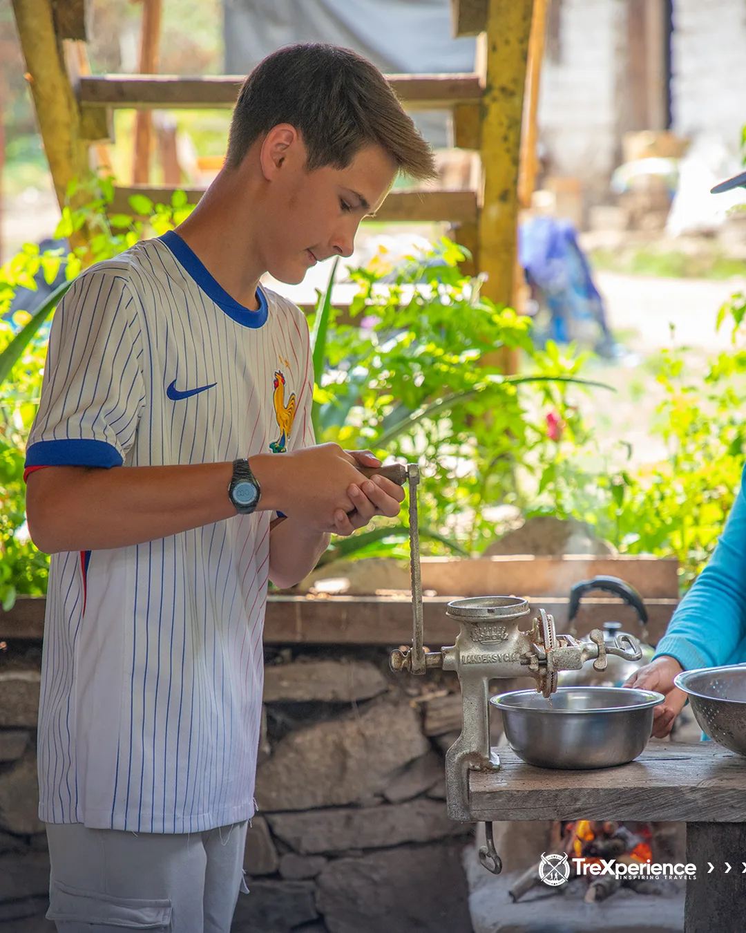 Boy grinding coffee in Santa Teresa - Salkantay Trek Guide | TreXperience