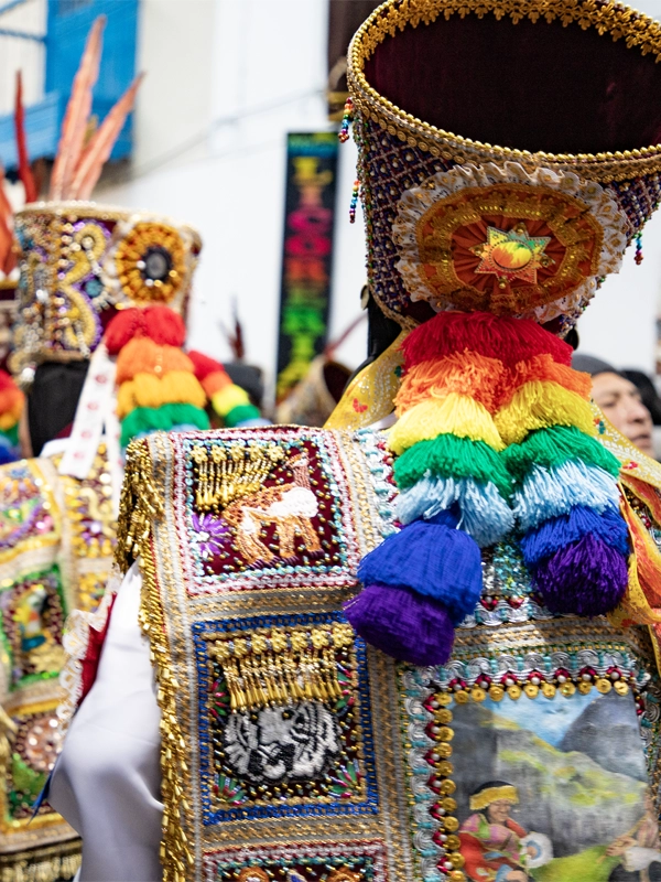 Dancers from the Paucartambo dance group wearing the colors of the Cusco flag Danzaq dancers from Paucartambo with the colors of the rainbow | TreXperience