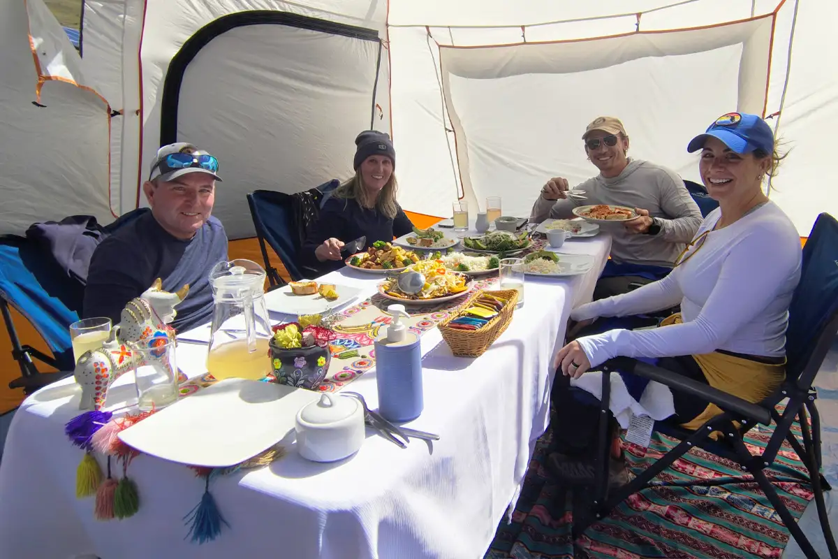 Lunch time, picnic meal at Rainbow Mountain Travelers enjoying lunch, picnic meal surrounded by mountain scenery during their Rainbow Mountain tour.