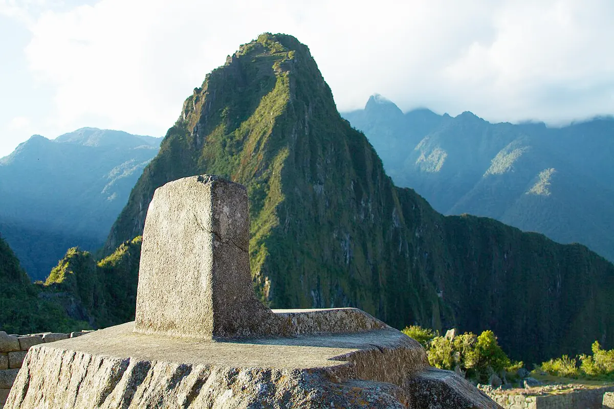 Intihuatana and afternoon shadows of Huayna Picchu Mountain Intihuatana and afternoon shadows of Huayna Picchu Mountain | TreXperience