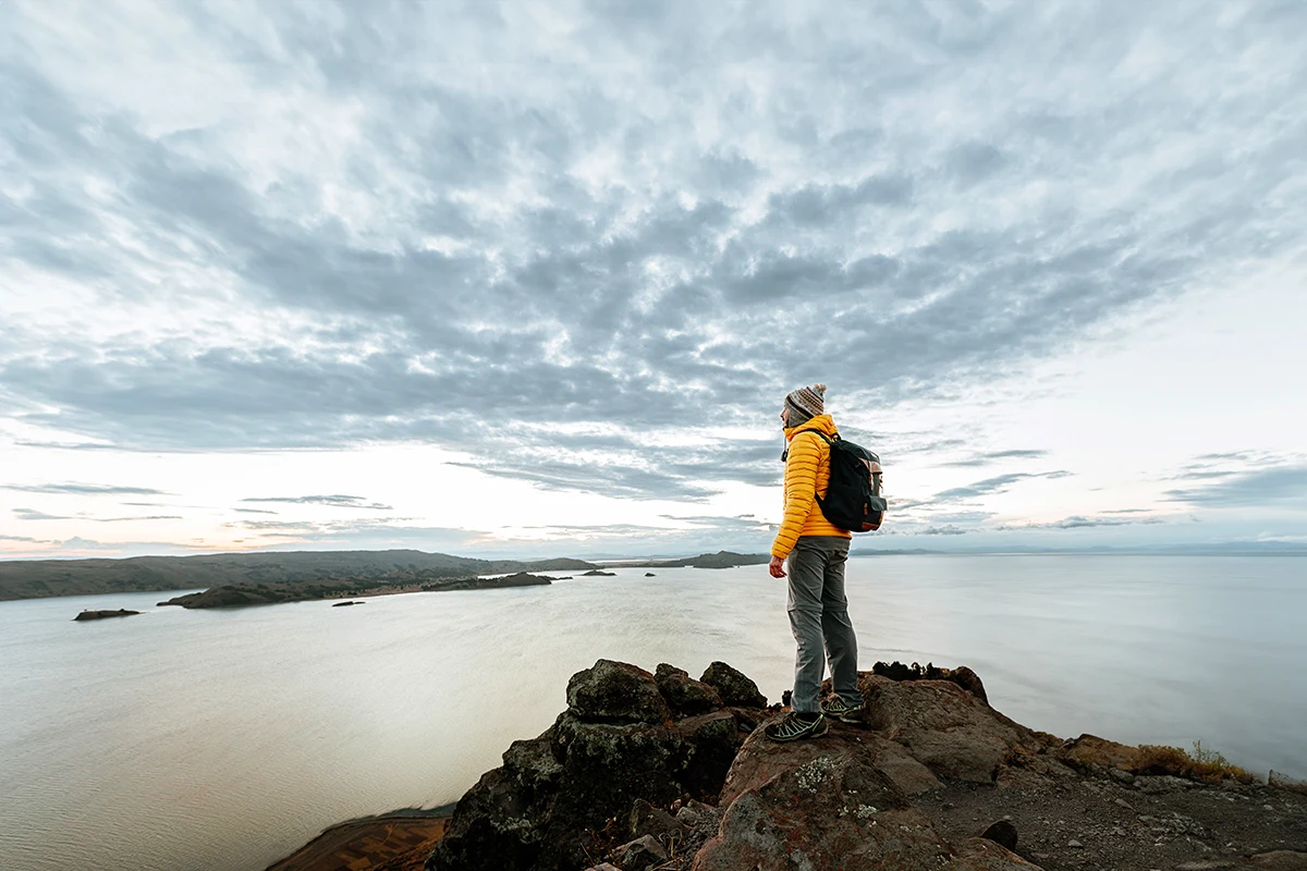 Man looking at a lake - Lake Titicaca Peru | TreXperience