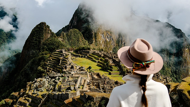 Woman looking at Machu Picchu - Luxury Tours to Machu Picchu | TreXperience