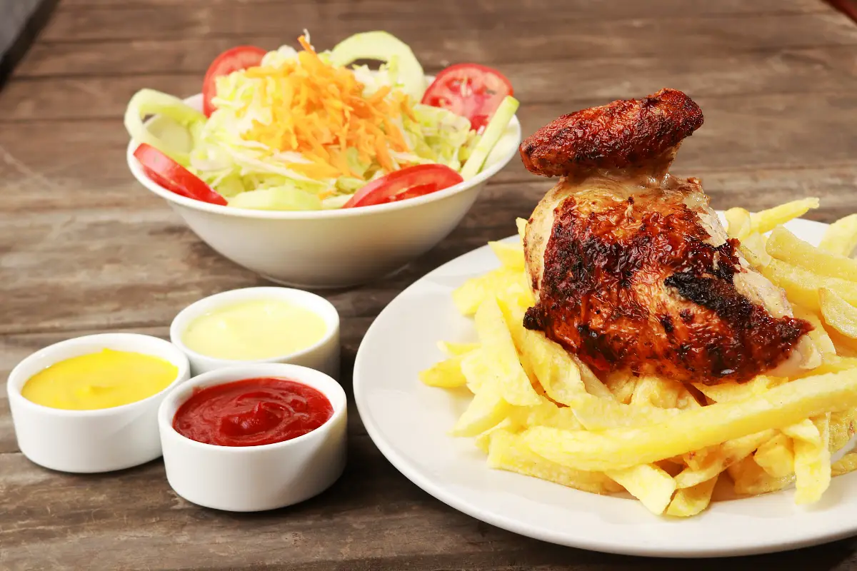 Pollo a la brasa whole with its sauces and salad | TreXperience