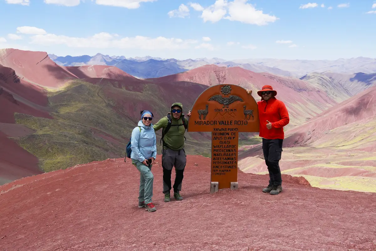 Tourist at Rainbow Mountain with Red Valley Views Tourist at Rainbow Mountain Red Valley in the background.