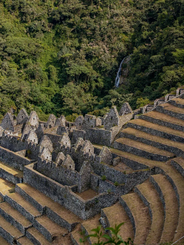 View of Wiñay Wayna: Inca Structures and Mountain Waterfall View of Wiñay Wayna: Inca Structures and Mountain Waterfall | TreXperience