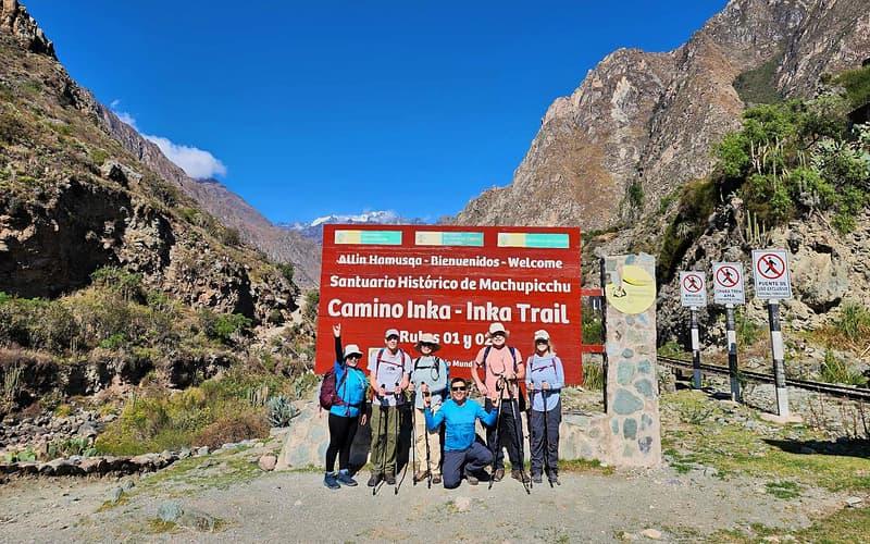 Group of hikers at the KM 82 sign where the Inca Trail begins, day one of the Luxury Inca Trail 5 Days