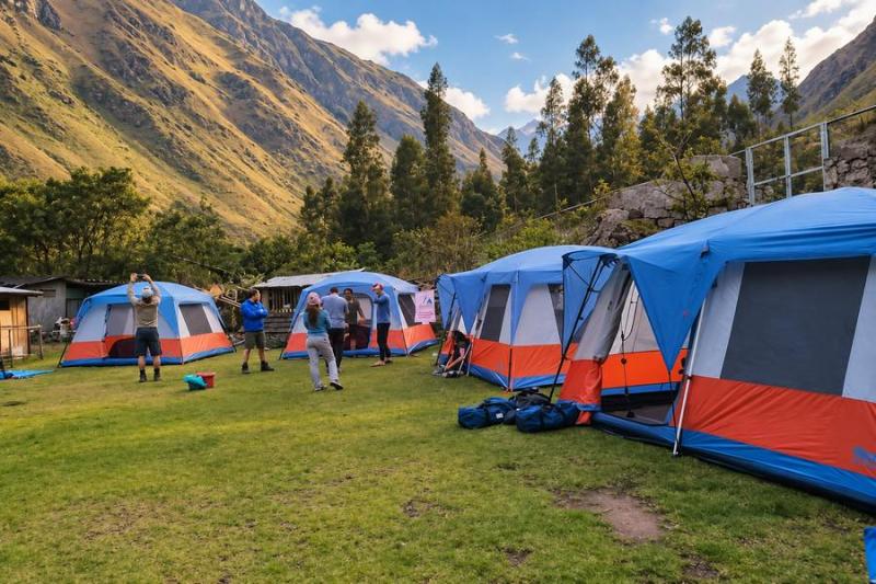 Hikers relaxing beside walk-in tents at the first campsite of the Luxury Inca Trail 4 days