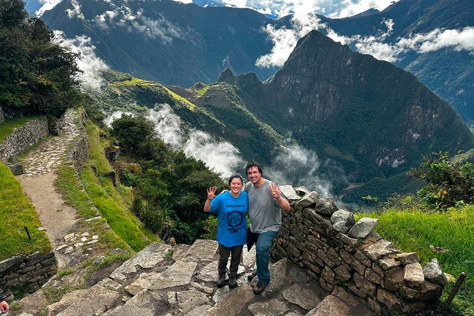 Traveler couple on the Inca Trail with Machu Picchu in the background | TreXperience