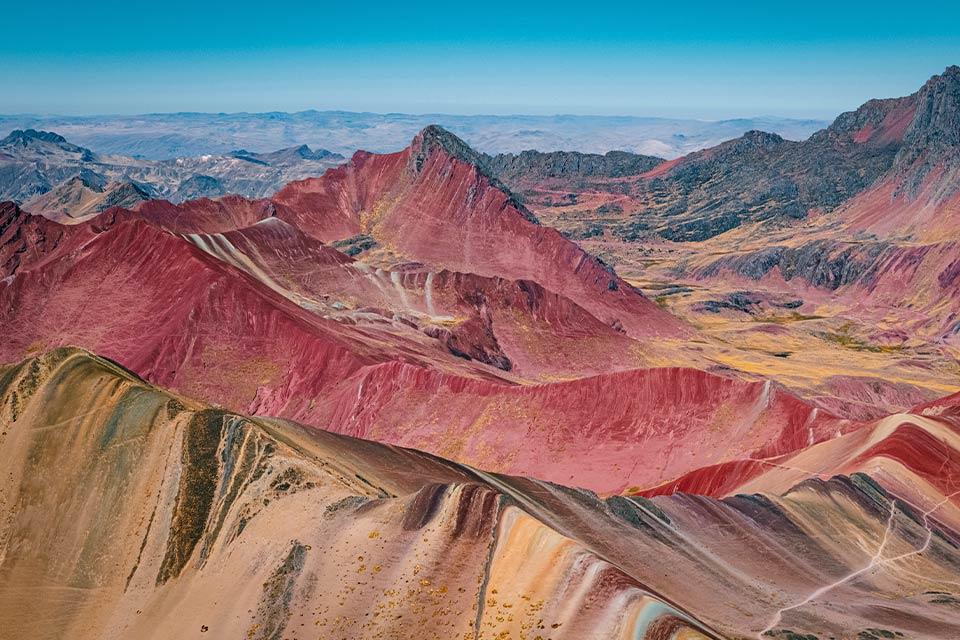 Wide view of red ridges and striped slopes across the Red Valley, Rainbow Mountain and Red Valley Premium Tour | TreXperience