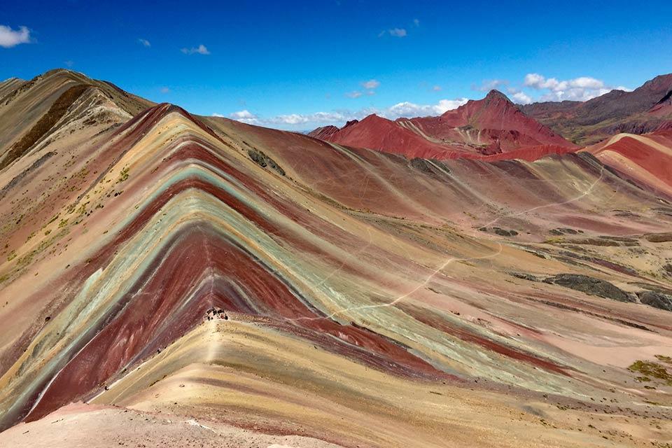 Ridge of Rainbow Mountain in Cusco with red, green, and beige bands, Rainbow Mountain and Red Valley Premium Tour | TreXperience