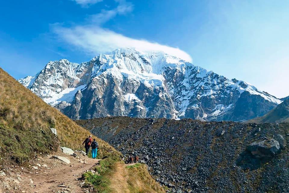 Hikers on the trail with Nevado Salkantay ahead under a blue sky, Salkantay Trek 5 Days to Machu Picchu | TreXperience