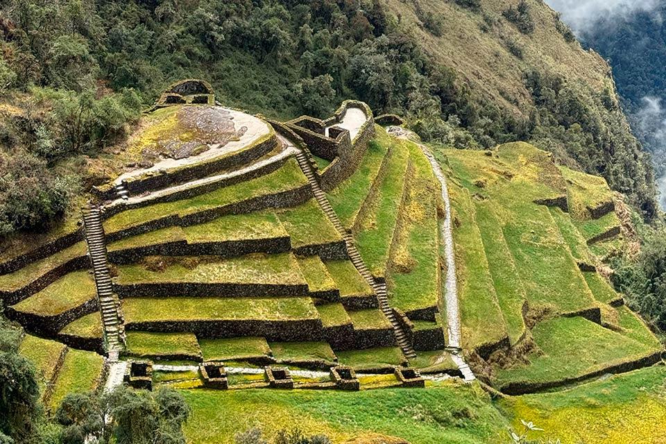 Inca ruins on a hillside with agricultural terraces and stone stairways (Ultimate Inca Trail Tour, 5 days) | TreXperience