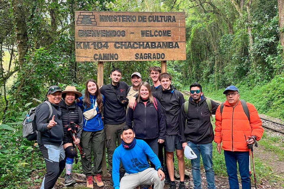 Group tour of 2 day Inca Trail one side of Chachabamba sign | TreXperience