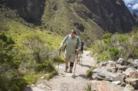 Man climbing stairs to Inti Punku at the Inca Trail | TreXperience