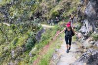 Tourist walking along the ancient Short Inca trail to Machu Picchu.
