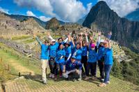 Traveler group celebrating at Machu Picchu with Huayna Picchu in the background (2-day Inca Trail camping) | TreXperience