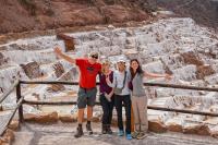 Traveler group posing with a panoramic view of the Maras Salt Mines (Maras, Moray & Chinchero half-day tour) | TreXperience