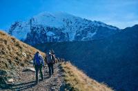 Hikers walk along a mountain trail with a snowcapped peak in the background, Salkantay Trek 4 Days to Machu Picchu | TreXperience