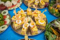 Gourmet appetizers of stuffed causa topped with egg and crispy garnish served at a buffet | TreXperience