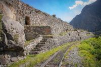Inca stone ruins beside the railway in the valley with mountains in the background (Ultimate Inca Trail Tour, 5 days) | TreXperience