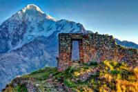 Stone gateway at Inti Punku on a ridge, with a massive snowcapped mountain in the background, Cachicata Inca Quarry Trek to Machu Picchu 4 Days 3 Nights | TreXperience