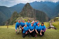 Tourist on the Machu Picchu stone citadel surrounded by lush green mountains | TreXperience