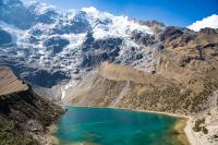 Humantay Lake with turquoise water in front of snow-covered Humantay Mountain | TreXperience