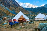 Salkantay Glamping camp with tents and chairs in front of Salkantay Mountain | TreXperience