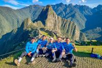 Friends with a tour guide with Machu Picchu as a background | TreXperience