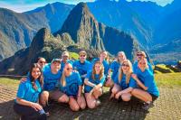Group of tourists with Machu Picchu as a background | TreXperience